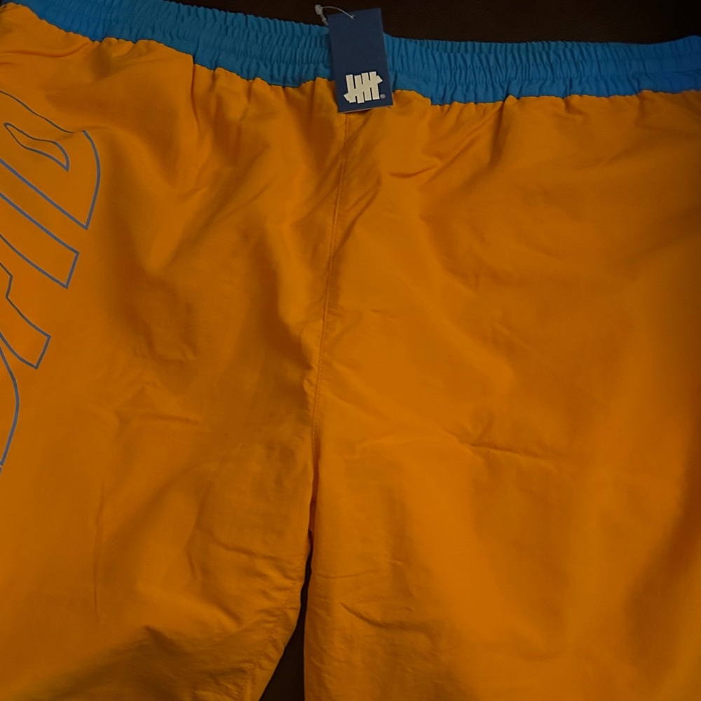 Undefeated Bright Orange Shorts with Blue Waistband